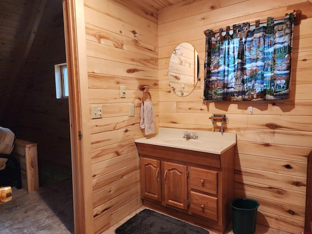 bathroom featuring wood walls and vanity