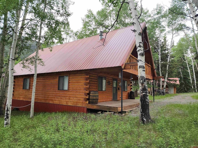 rear view of property with a wooden deck