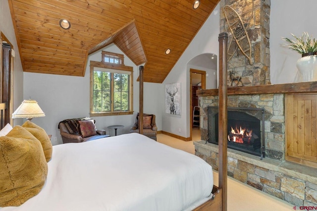 carpeted bedroom with wooden ceiling, a closet, a fireplace, and lofted ceiling