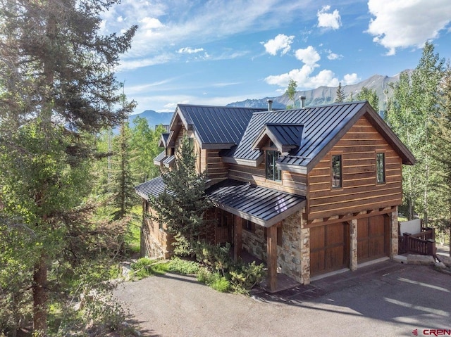 view of front of property featuring a garage and a mountain view