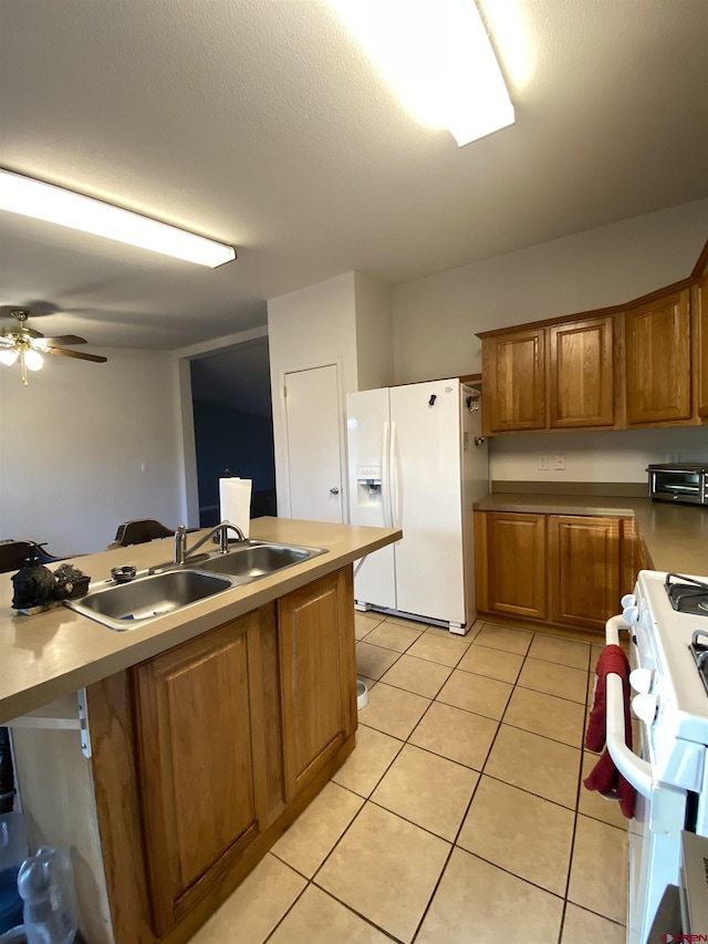 kitchen featuring ceiling fan, sink, light tile patterned floors, and white appliances