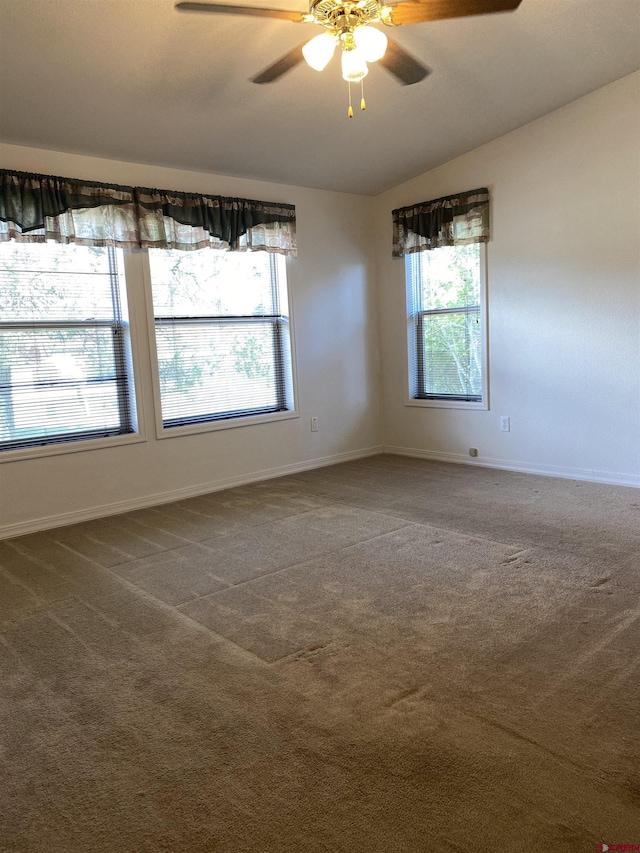 empty room with ceiling fan and carpet flooring