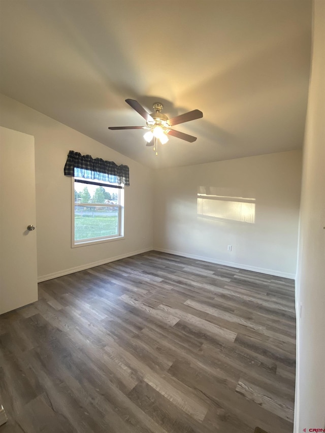 spare room featuring ceiling fan, dark hardwood / wood-style floors, and vaulted ceiling