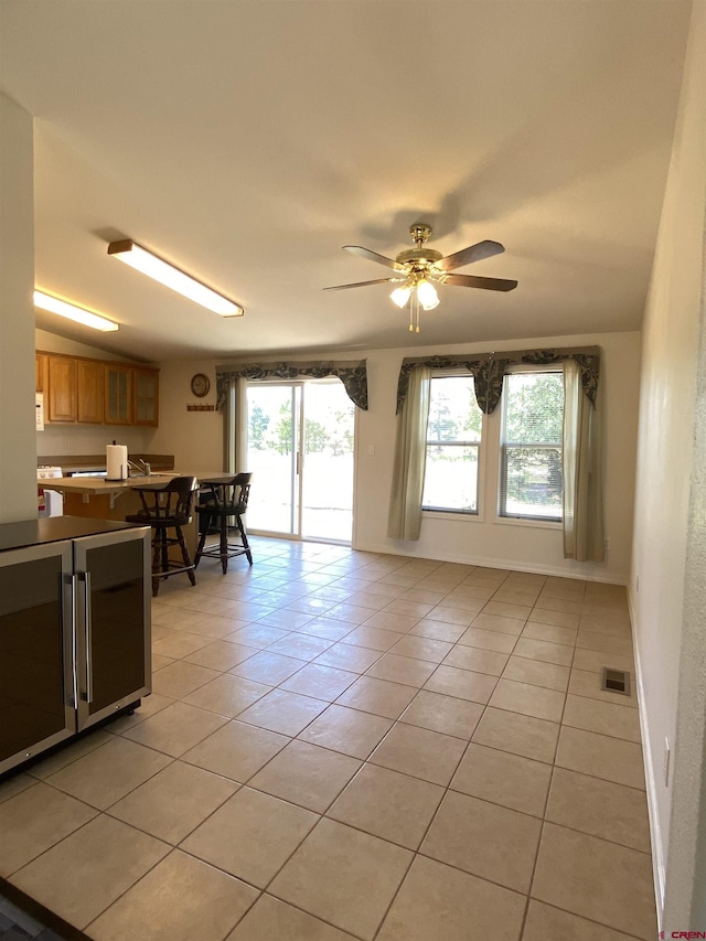 interior space with light tile patterned flooring and ceiling fan