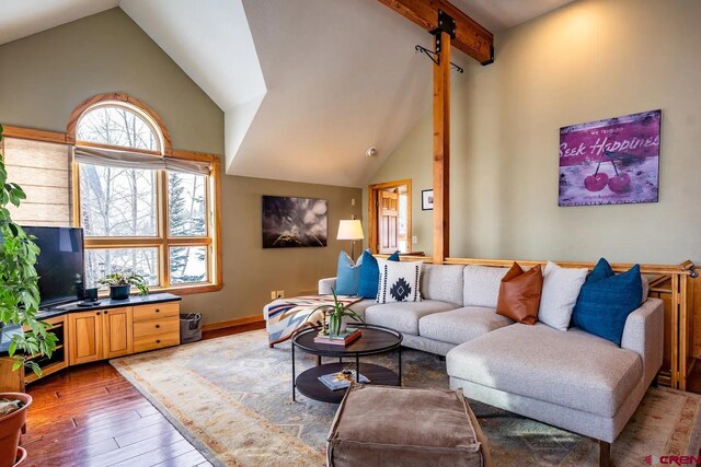 living room with beam ceiling, high vaulted ceiling, a wealth of natural light, and hardwood / wood-style floors