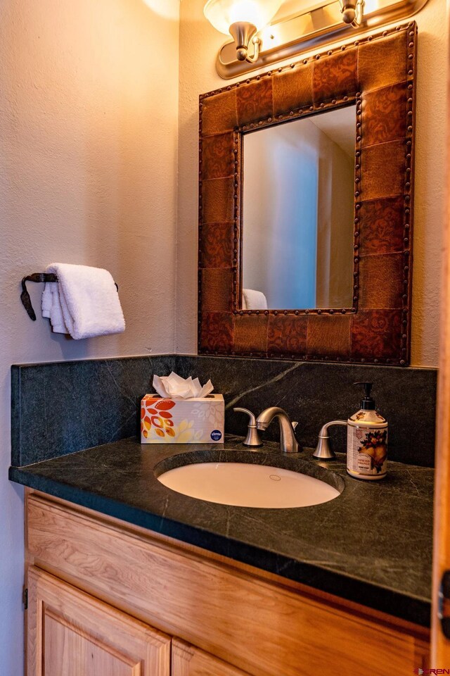 bathroom with vanity and tasteful backsplash