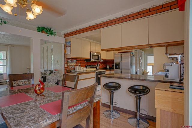 dining space with a healthy amount of sunlight, light hardwood / wood-style flooring, and ceiling fan