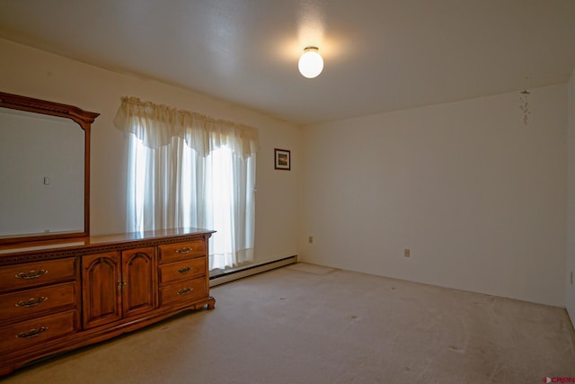 unfurnished room with baseboard heating and light colored carpet