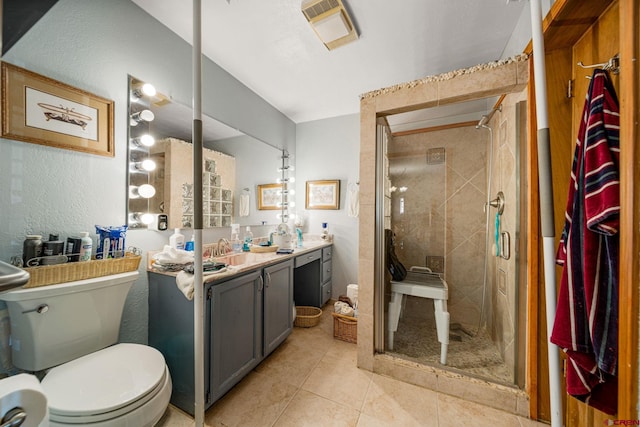 bathroom featuring vanity, toilet, tile patterned floors, and walk in shower