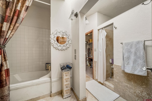 bathroom with shower / bathtub combination with curtain and tile patterned floors