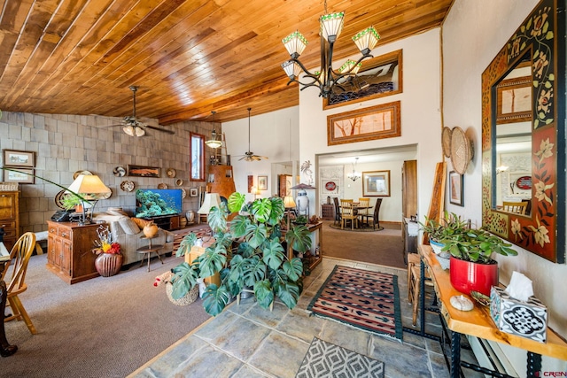 living room featuring tile walls, wooden ceiling, carpet floors, and ceiling fan