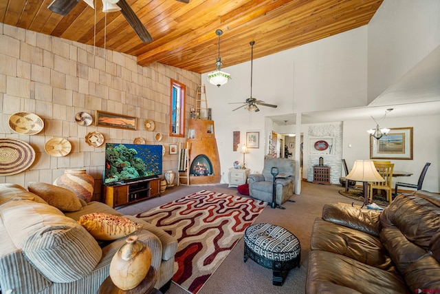 living room featuring ceiling fan with notable chandelier, carpet, wood ceiling, and a fireplace