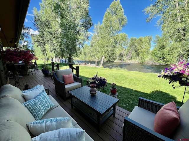 wooden deck with a yard, a water view, and an outdoor hangout area