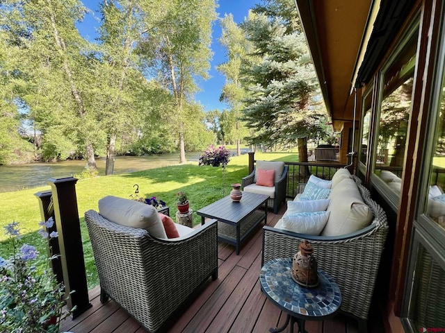 deck with an outdoor living space and a yard