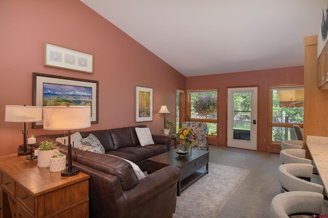 living area with a baseboard heating unit, carpet floors, and lofted ceiling