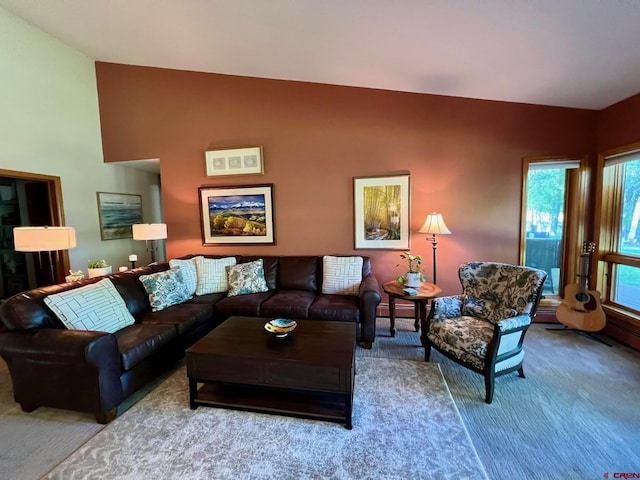 living area with carpet and vaulted ceiling