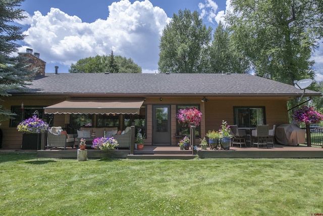 back of property featuring an outdoor living space, a lawn, a chimney, and a shingled roof