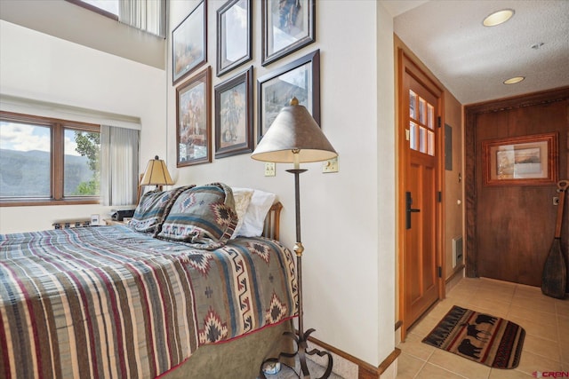 tiled bedroom featuring a textured ceiling