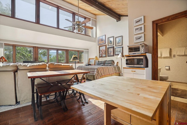 dining space with wood ceiling, dark hardwood / wood-style floors, ceiling fan, and beam ceiling