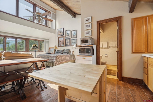 dining room with dark hardwood / wood-style floors, beamed ceiling, high vaulted ceiling, and ceiling fan