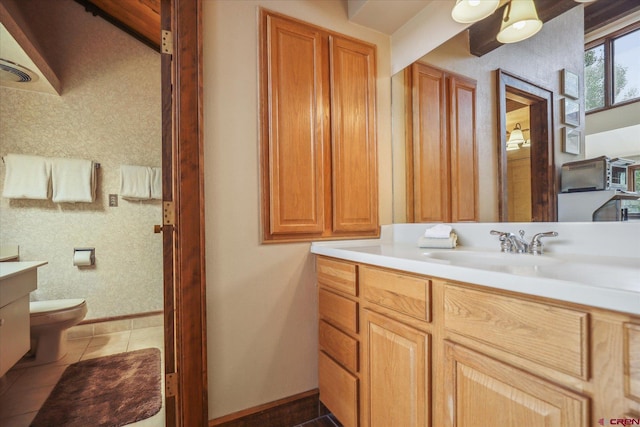 bathroom featuring tile patterned flooring, toilet, and vanity