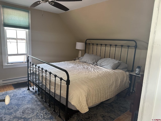 bedroom with a baseboard radiator, dark hardwood / wood-style floors, ceiling fan, and vaulted ceiling