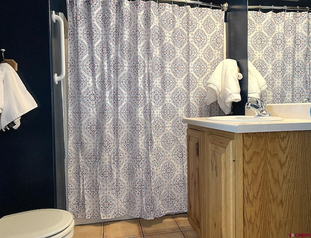 bathroom featuring tile patterned floors, toilet, and vanity