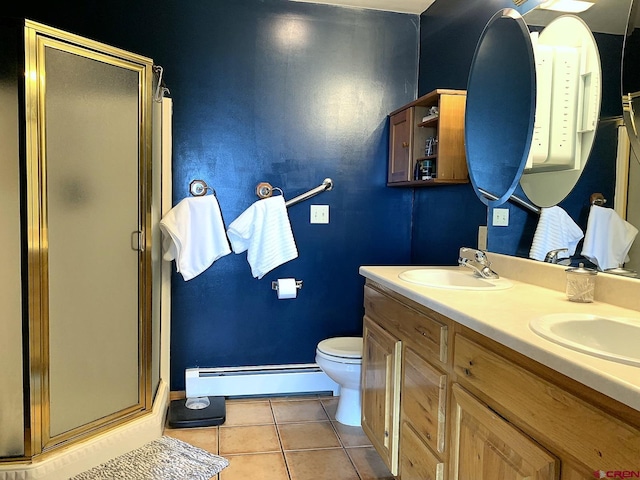 bathroom with a shower with door, double vanity, toilet, tile patterned floors, and a baseboard radiator