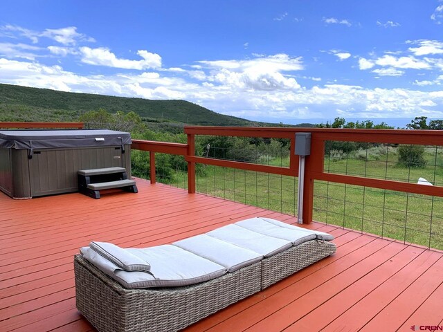 wooden terrace featuring a hot tub