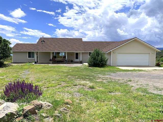 ranch-style house featuring a garage and a front lawn