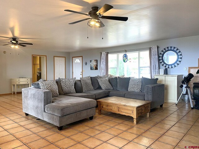 tiled living room featuring ceiling fan