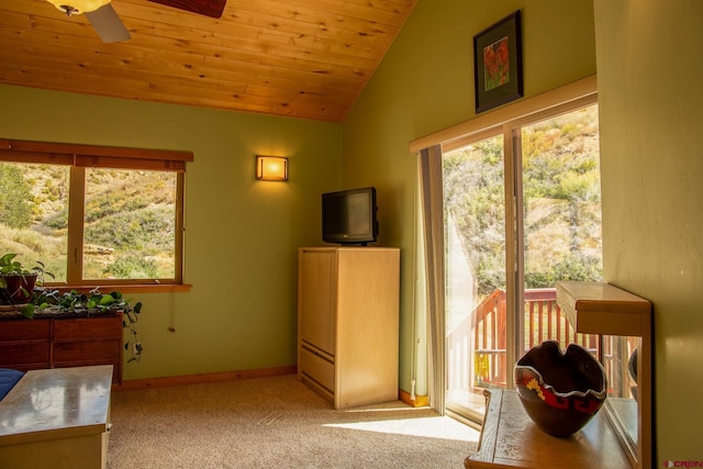 interior space featuring lofted ceiling, wood ceiling, light carpet, ceiling fan, and baseboards