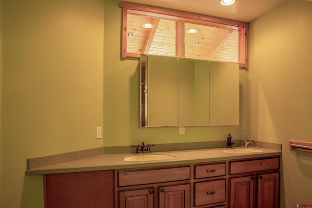 full bathroom featuring double vanity, a sink, and recessed lighting