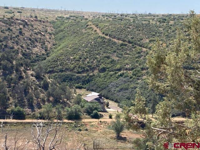 birds eye view of property featuring a view of trees