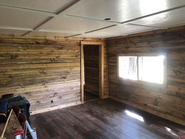 empty room with dark hardwood / wood-style flooring and wooden walls