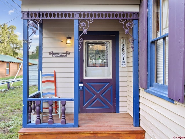 view of exterior entry with covered porch