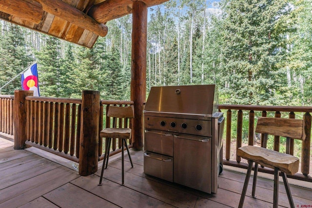 wooden deck with a baseboard heating unit and grilling area