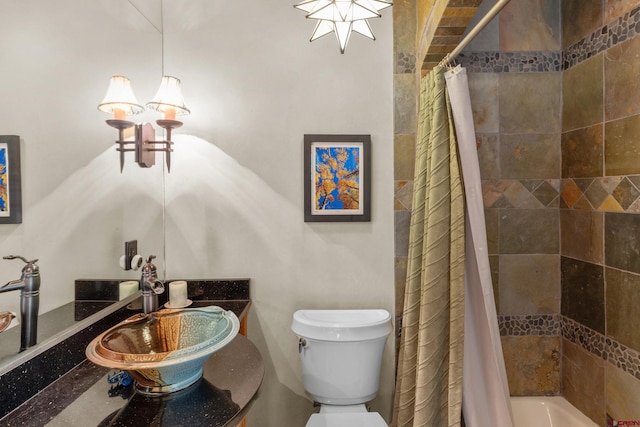 full bathroom featuring sink, toilet, and shower / bathtub combination with curtain