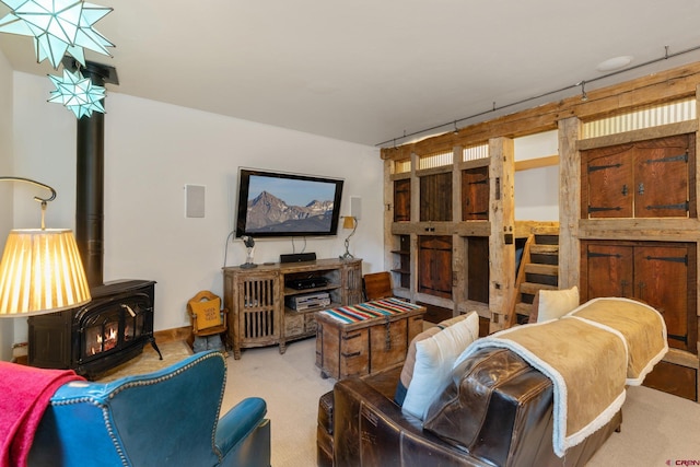 living room with carpet flooring and a wood stove