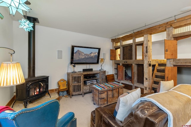 living room with a wood stove and carpet flooring