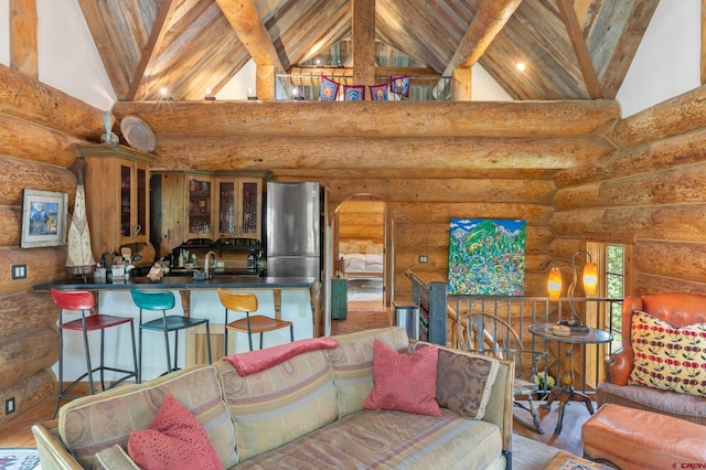 living room with high vaulted ceiling, beamed ceiling, sink, log walls, and wood ceiling