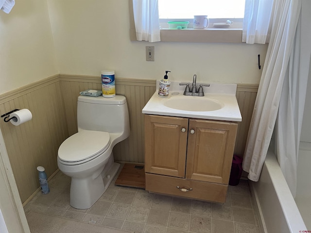 full bathroom featuring vanity, shower / bath combination with curtain, tile patterned floors, and toilet