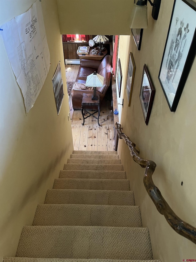 stairs featuring a baseboard radiator