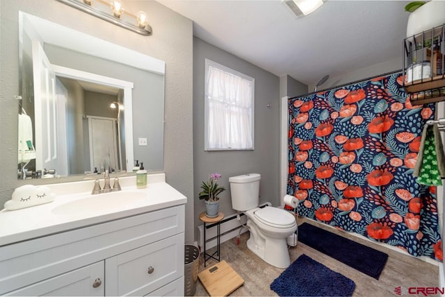 bathroom featuring vanity and toilet