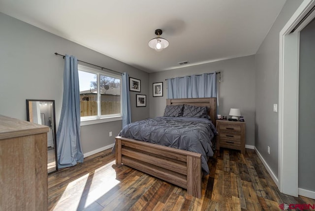 bedroom with dark hardwood / wood-style flooring