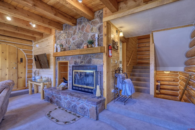 living room featuring a stone fireplace, beam ceiling, wood walls, wood ceiling, and log walls