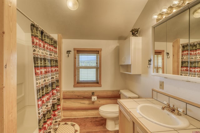 bathroom featuring vanity, hardwood / wood-style floors, toilet, and walk in shower