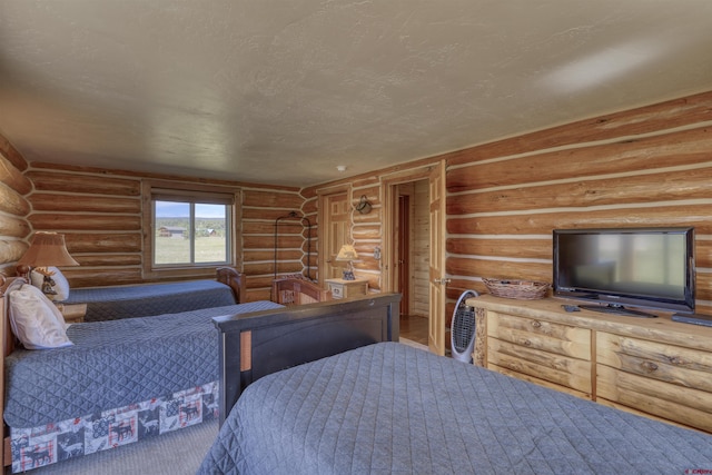 bedroom featuring rustic walls and a textured ceiling