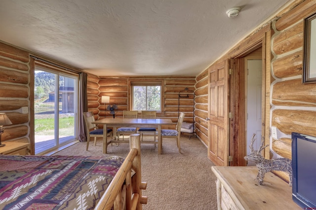 interior space with log walls and a textured ceiling