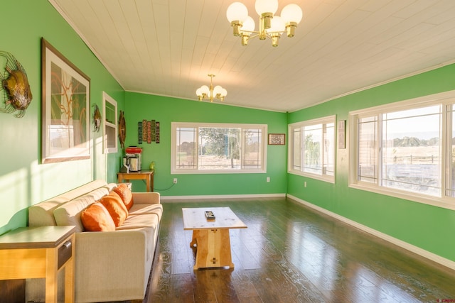 living room with baseboards, crown molding, a chandelier, and hardwood / wood-style floors